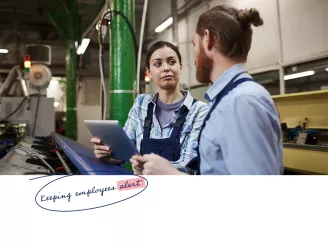 Factory workers using a tablet